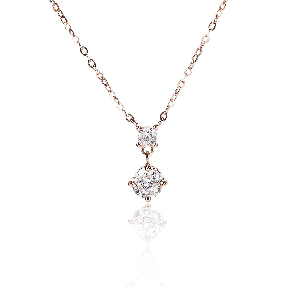 שרשרת רוז גולד עם תליון כפול שאוחז שתי אבני זרקון מהממות